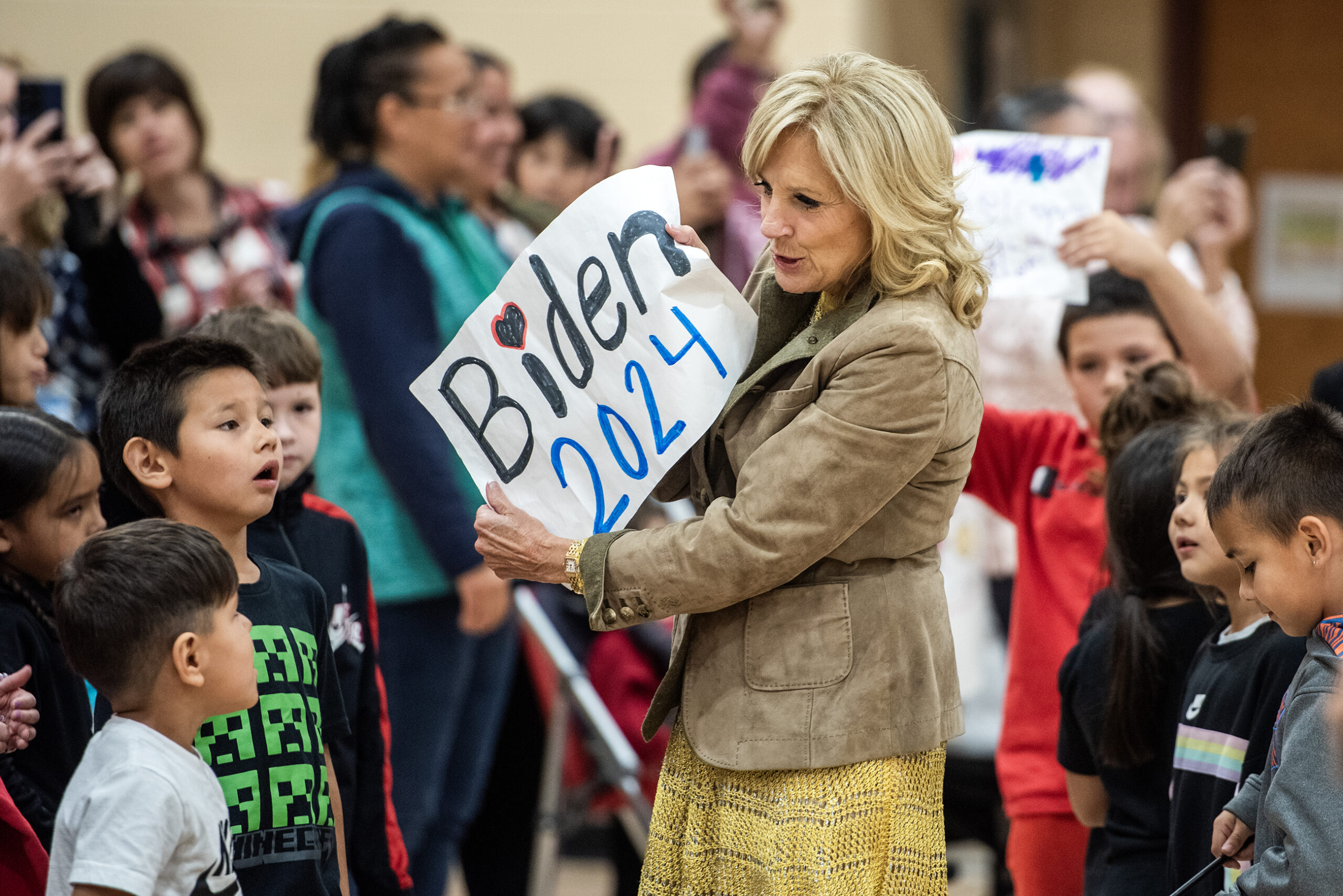 Jill Biden holds a sign that says